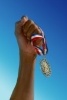 5722353-hand-holding-gold-medal.jpg